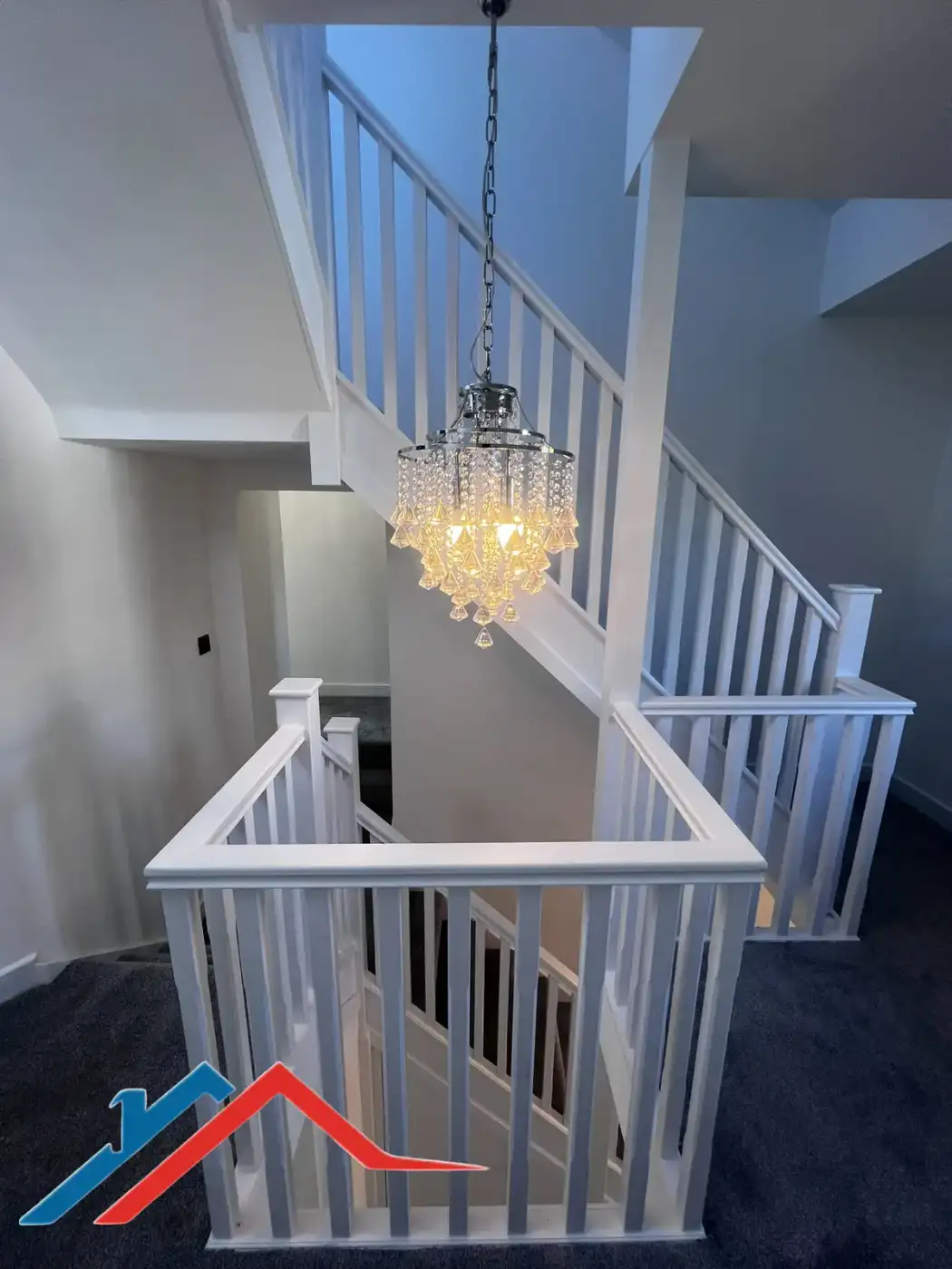 Stairwell with a chandelier and new balustrade
